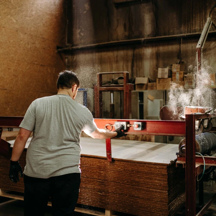 Un homme de dos dans un atelier semble travailler à une machine